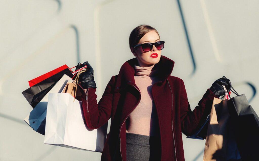 customer loyalty photo of woman holding white and black paper bags